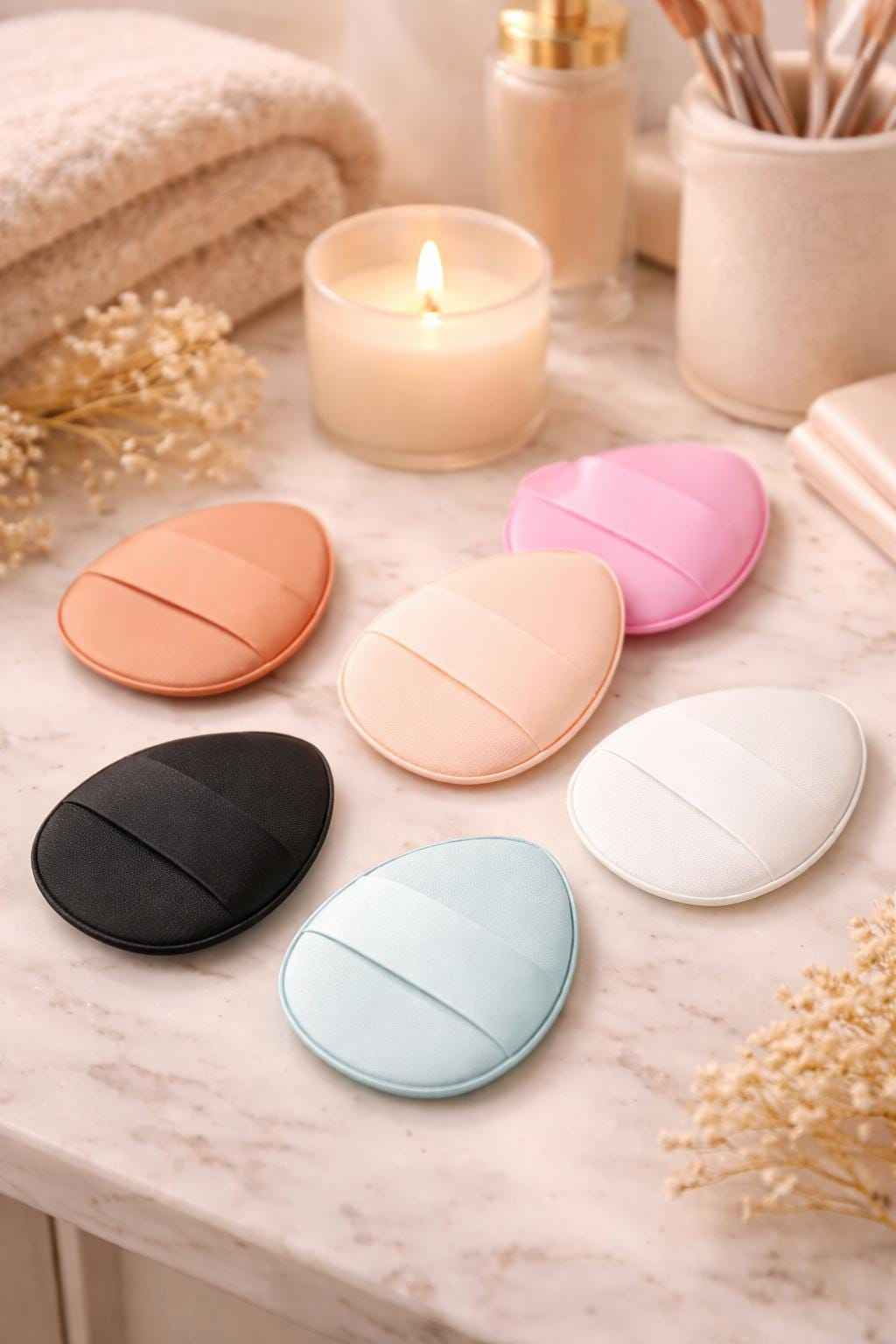 Assorted finger makeup sponges displayed on vanity countertop for precise cosmetic blending and touch-up application