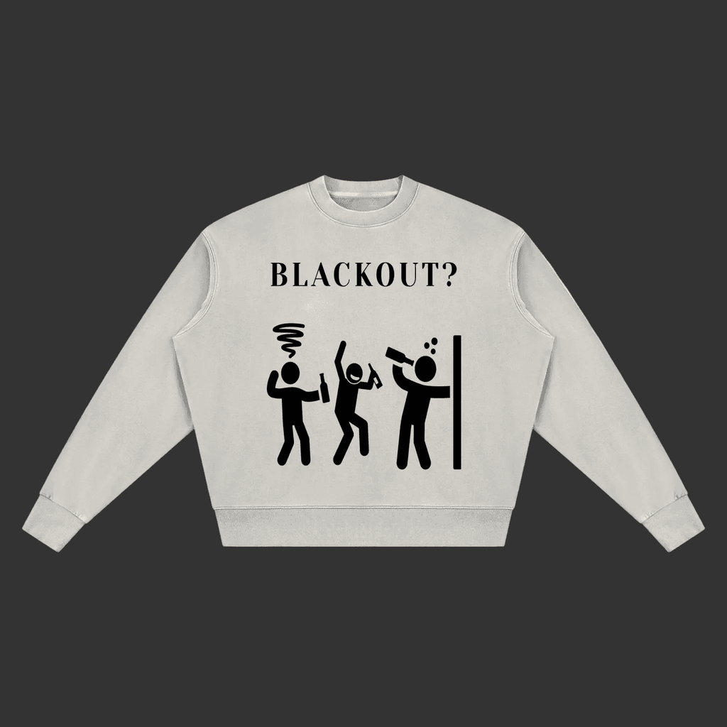 A light gray crewneck sweatshirt featuring a black graphic print on the front with the text 'BLACKOUT?' above three stick figures in various states of blackout or power outage, displayed on a clean gray background.