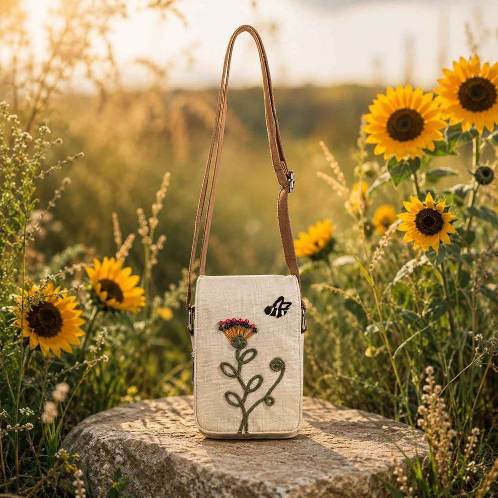 Boho floral crossbody phone pouch with embroidered flower design displayed in a sunflower garden setting