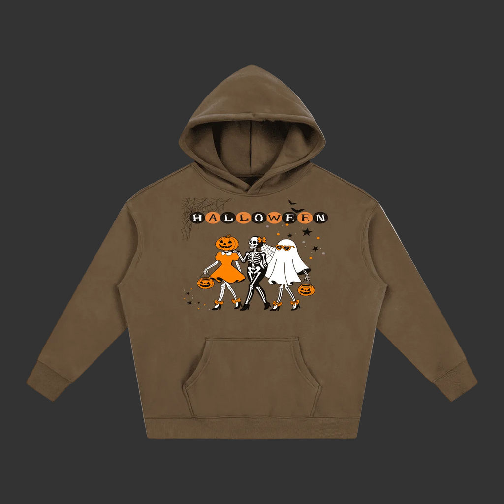 A brown pullover hoodie with a Halloween graphic on the chest, featuring the word 'HALLOWEEN' above three cartoon characters dressed as a pumpkin, a skeleton, and a ghost, shown on a plain gray background.