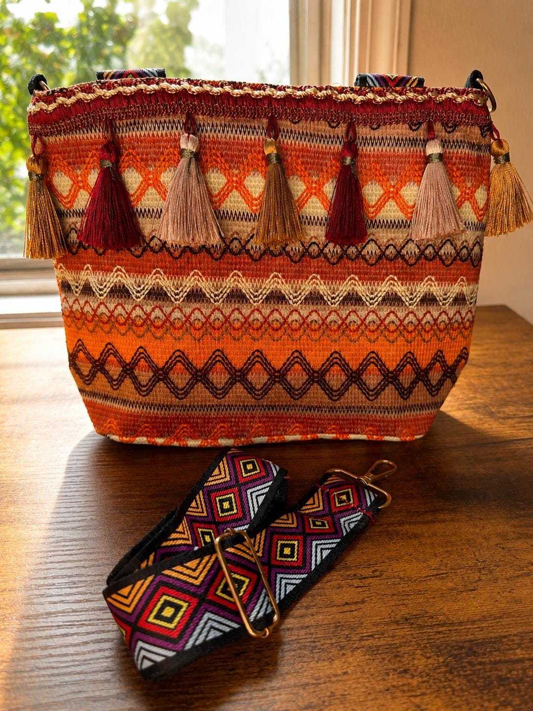 Patterned woven shoulder bag with tassels and adjustable strap