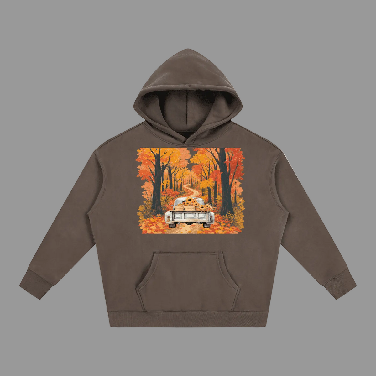 A dark brown pullover hoodie with a front kangaroo pocket and a large square graphic print on the chest depicting a vintage car driving down a road lined with colorful autumn trees.