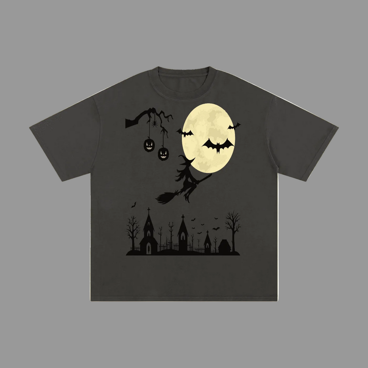 A dark charcoal gray short-sleeve t-shirt with a Halloween graphic print featuring a full moon, bats, a witch on a broomstick, jack-o'-lanterns, and a cemetery silhouette.