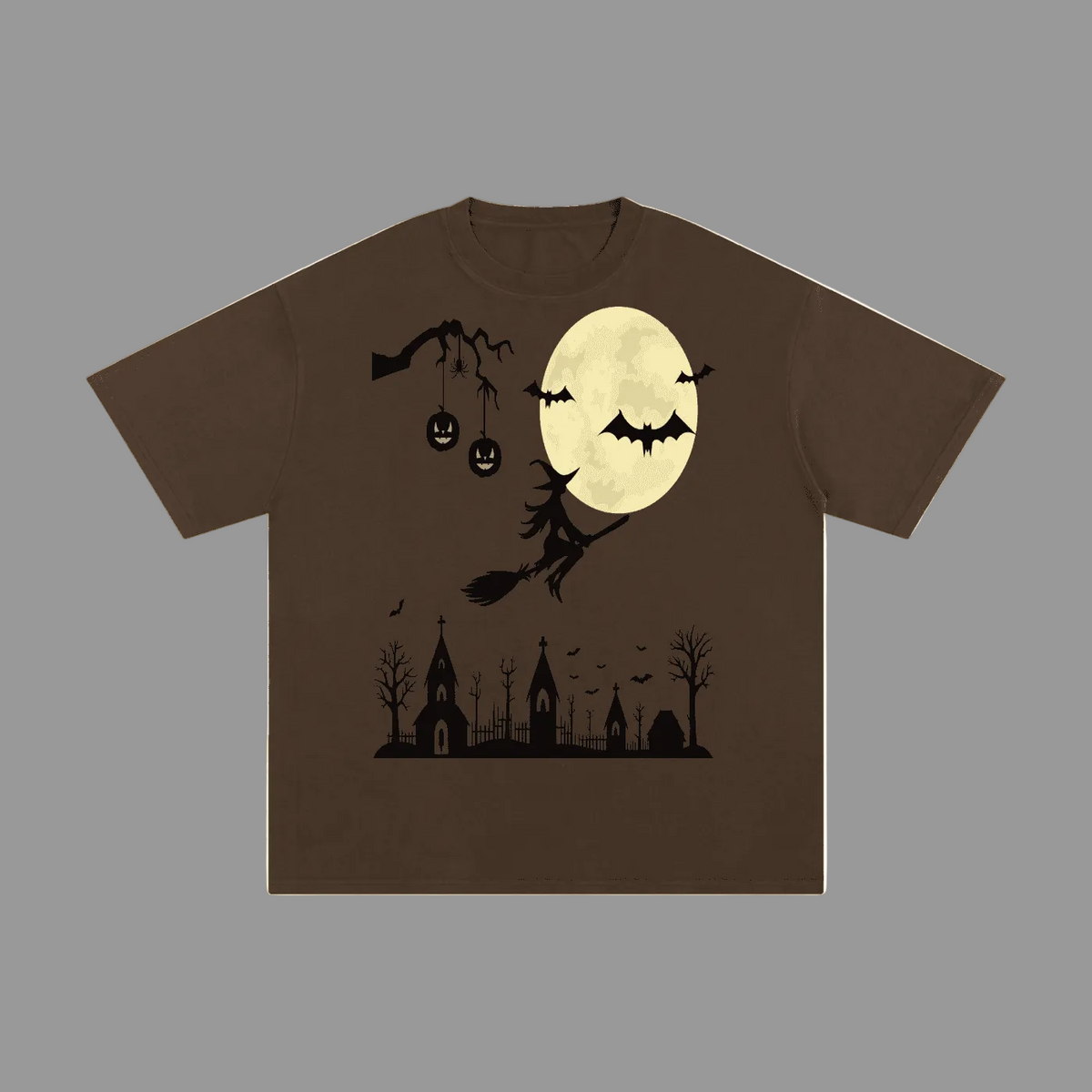 A brown short-sleeve crewneck t-shirt featuring a Halloween graphic print on the front, including a full moon, bats, a witch on a broomstick, jack-o'-lanterns, and a spooky graveyard silhouette.