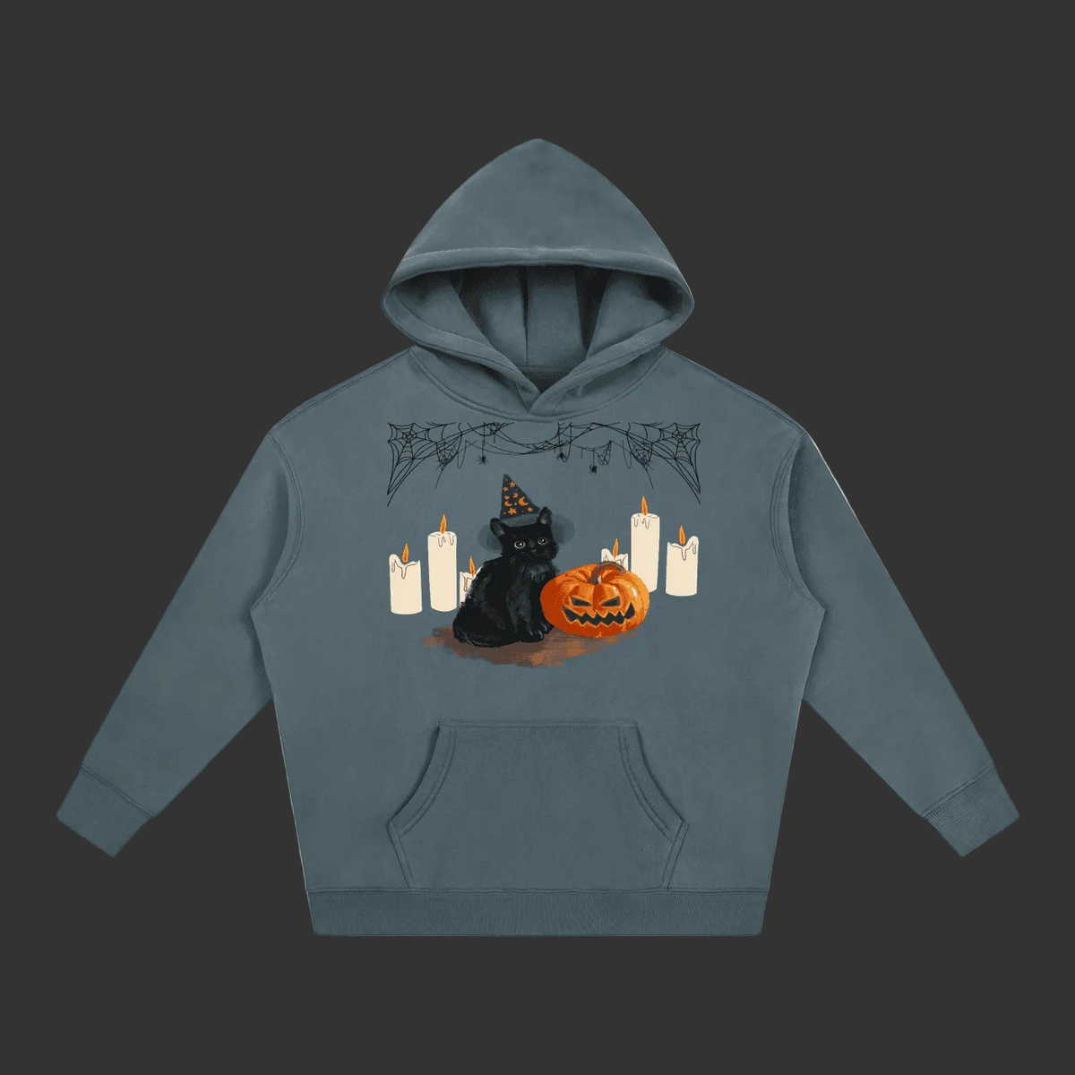A slate blue-gray pullover hoodie featuring a Halloween graphic of a black cat in a witch hat next to a carved orange pumpkin, surrounded by white candles and spiderwebs, shown on a plain gray background.