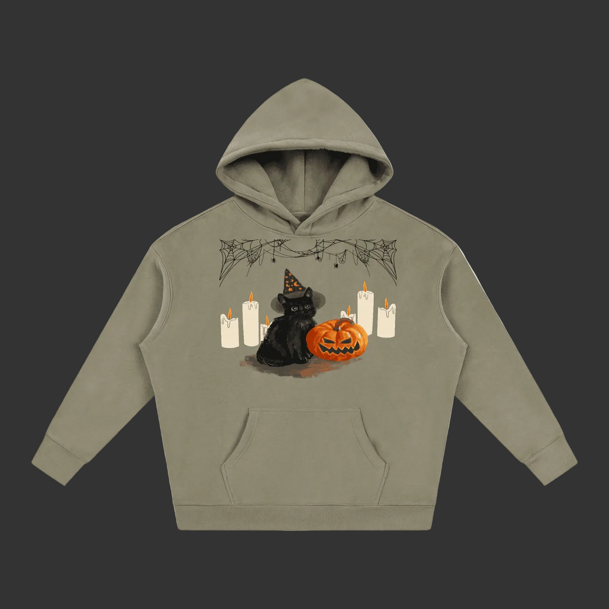 A sage green pullover hoodie with a Halloween graphic on the chest, featuring a black cat in a witch hat next to a jack-o'-lantern pumpkin and white candles, shown on a plain gray background.
