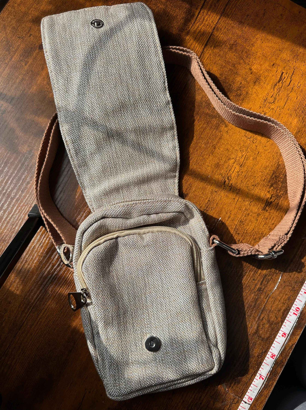 Front view of boho floral crossbody phone pouch with adjustable shoulder strap and compact hands-free design