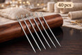 Large-eye hand sewing needles stored in a wooden needle case for easy threading and sewing projects