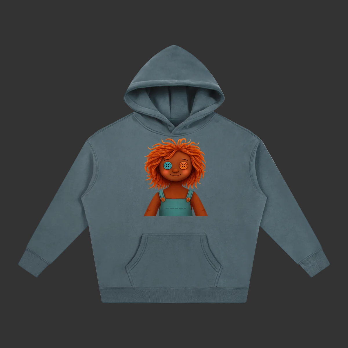 A slate blue-gray pullover hoodie with a graphic of a doll with orange hair and a blue dress on the chest, displayed on a solid gray background.