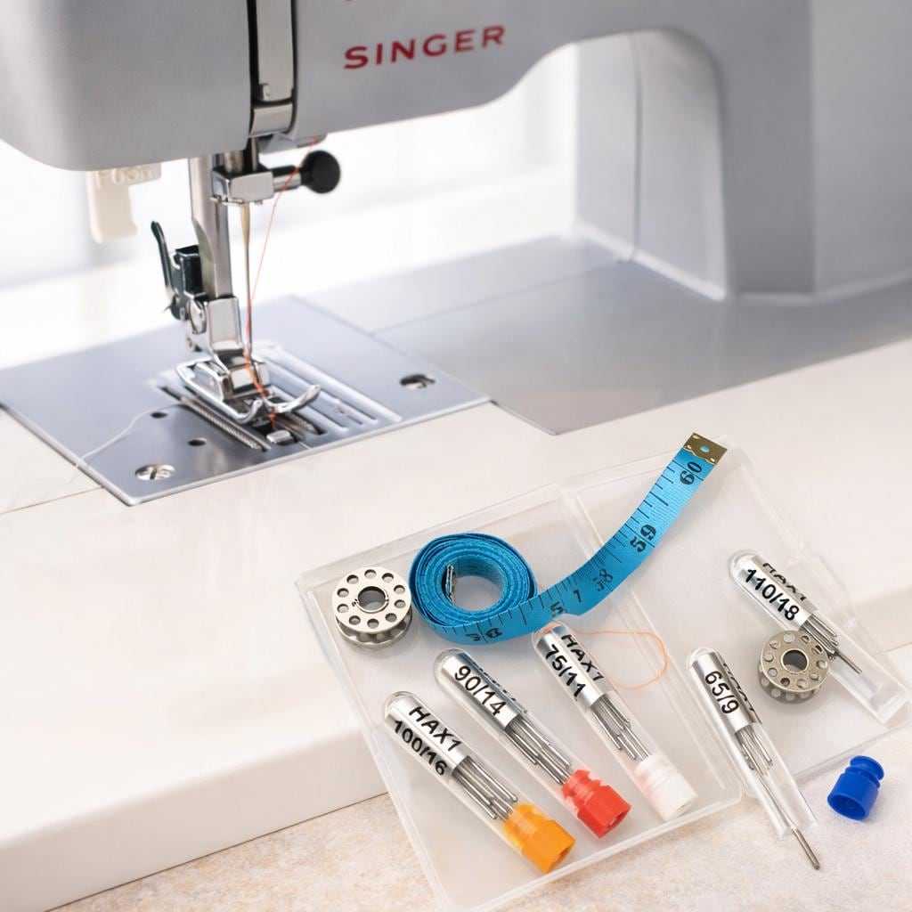 Sewing machine needles with thread and bobbins on a sewing machine