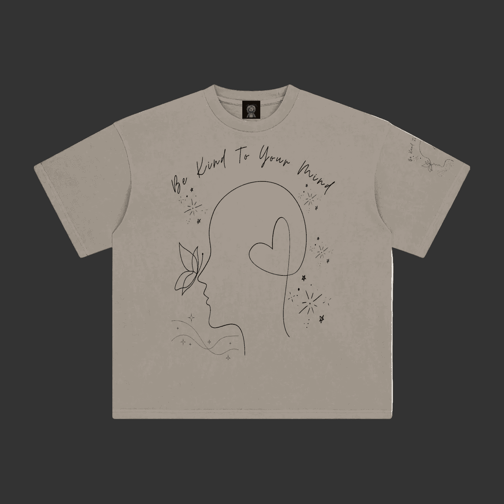 A light gray short-sleeve t-shirt with a black line art graphic of a profile silhouette, a heart, and the text 'We Kind To Your Friend' on the front, displayed flat against a gray background.