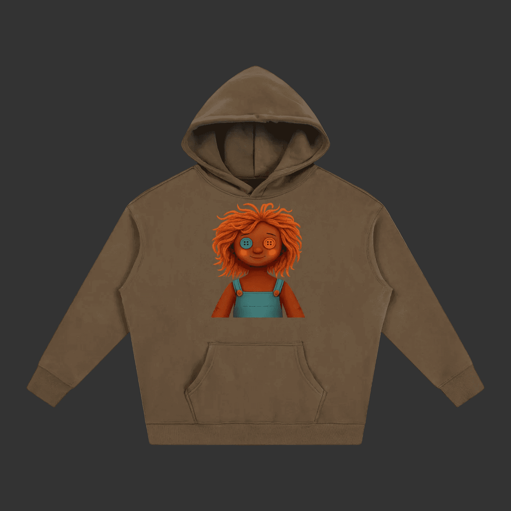 A brown pullover hoodie with a graphic print of a cartoon doll with orange hair and blue overalls on the chest, displayed on a solid gray background.