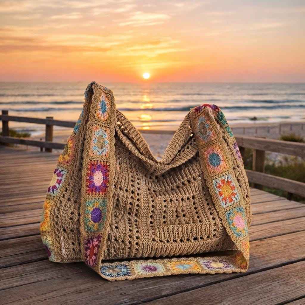 Boho crochet tote bag with granny square details on wooden deck at sunset