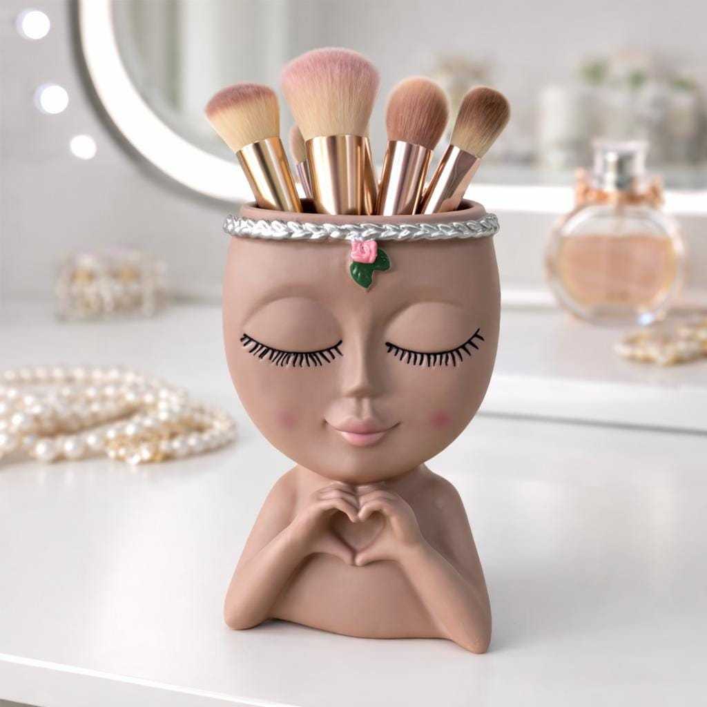 Makeup brush organizer with cosmetic brushes displayed in stylish face-shaped container for bathroom or vanity storage