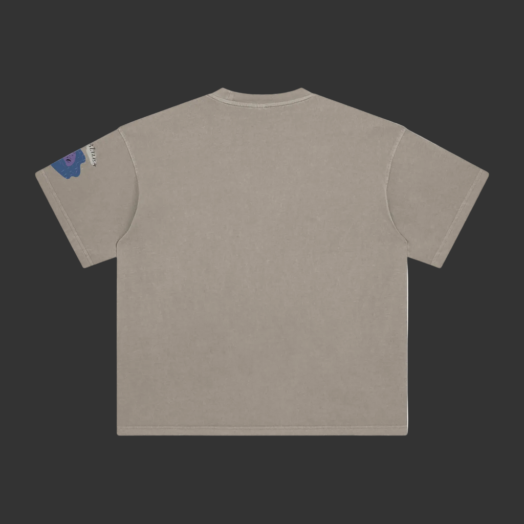 A short-sleeve crewneck t-shirt shown from the back, in a washed taupe color. A small blue and white graphic is printed on the left sleeve.