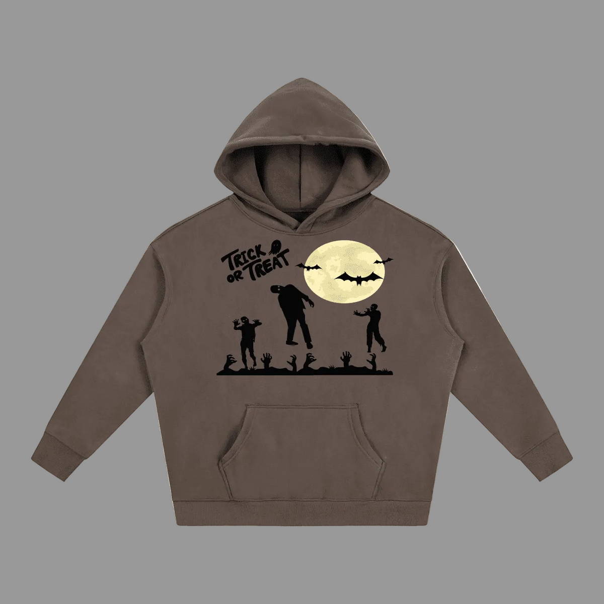 A dark brown pullover hoodie featuring a Halloween-themed graphic print on the front. The graphic includes a large cream-colored full moon, black bats, a witch riding a broomstick, a spooky church silhouette, and jack-o'-lanterns hanging from a branch.