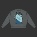 A dark gray crewneck sweatshirt featuring a graphic print of a light blue, stylized character with black hair-like loops and small mint green accents, displayed on a solid gray background.
