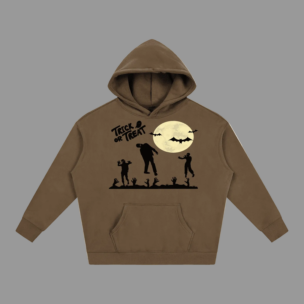 A brown pullover hoodie with a black graphic of a full moon, bats, silhouettes of children and a zombie, and the text 'Treat or Treat' on the chest, shown against a plain gray background.