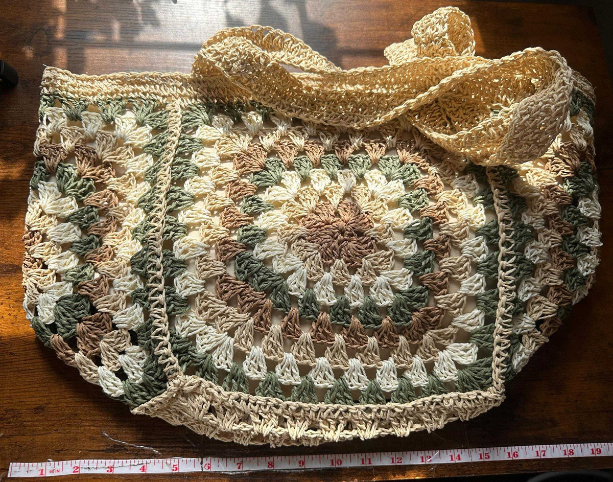 Boho crochet tote bag laid flat with measuring tape showing overall width and size dimensions