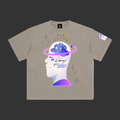 A taupe gray short-sleeve t-shirt with a graphic of a white human head profile showing a blue starry brain, a pink ring, and the text 'it always gets better'.