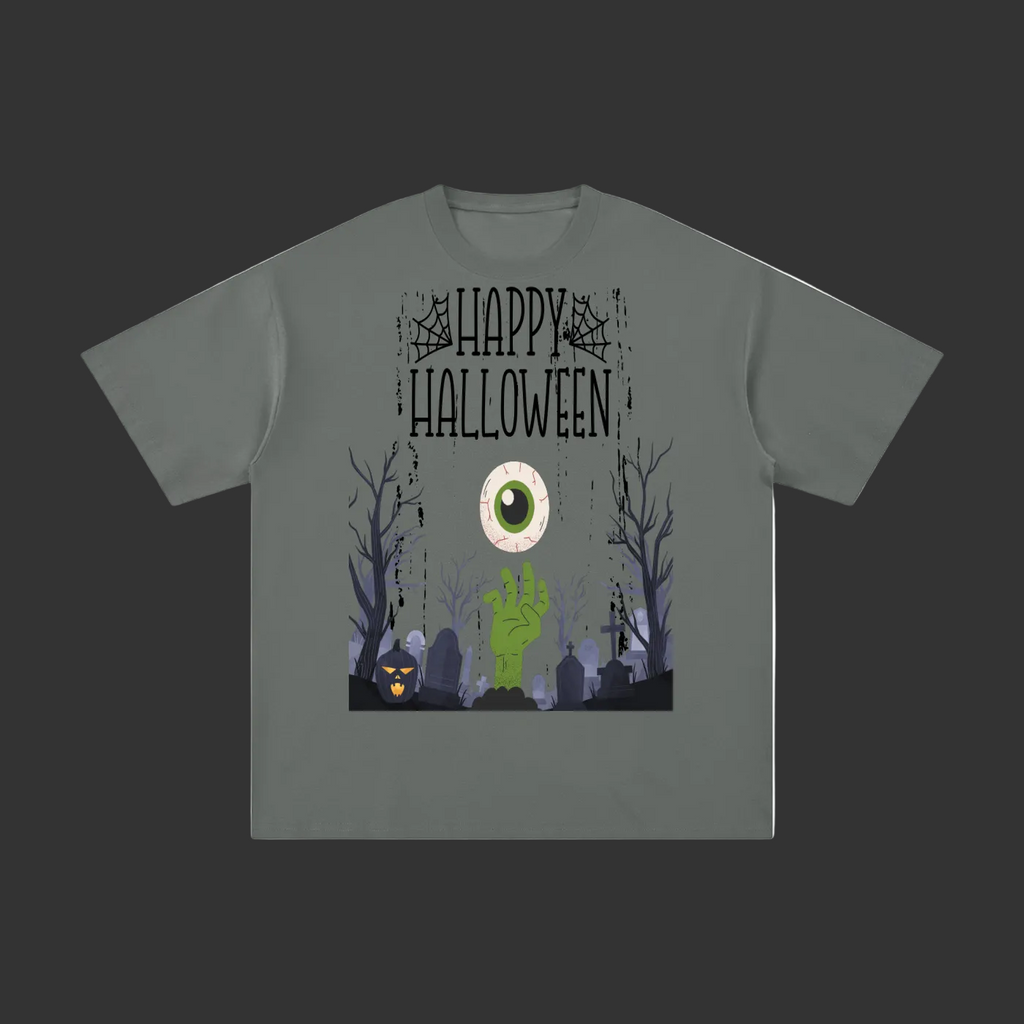 A dark gray short-sleeve t-shirt with a Halloween graphic on the front. The graphic features the text 'Happy Halloween' in a distressed font, a large green and white eye, a green zombie hand, a pumpkin, and a spooky graveyard scene with bare trees.