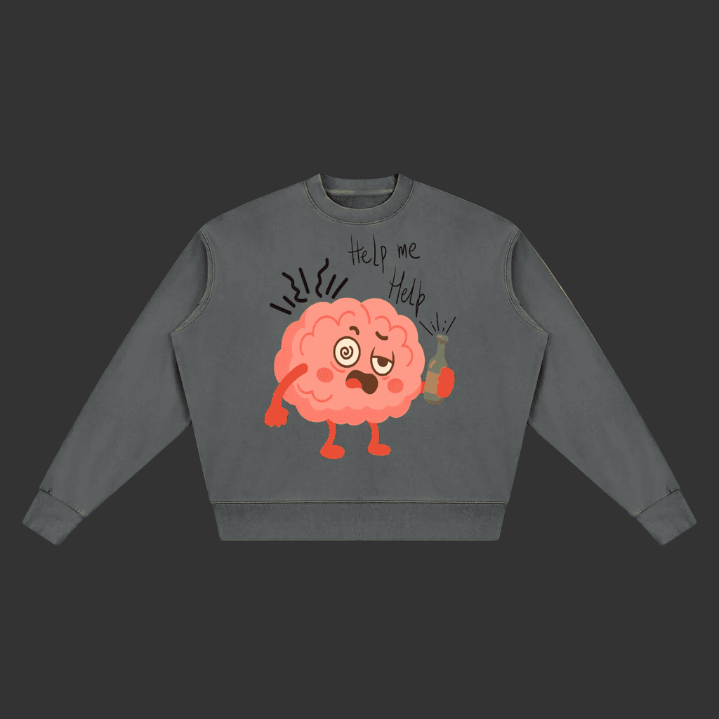 A dark gray crewneck sweatshirt featuring a cartoon graphic of a distressed pink brain holding a green bottle, with the handwritten text 'Help me Help' above it, displayed on a clean gray background.