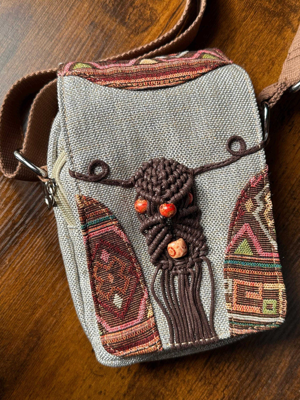 Close-up of boho woven crossbody bag with decorative beads and embroidery