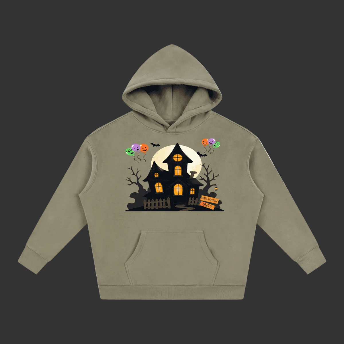 A sage green pullover hoodie with a Halloween-themed graphic on the chest featuring a haunted house, full moon, bats, and colorful balloons, shown against a plain gray background