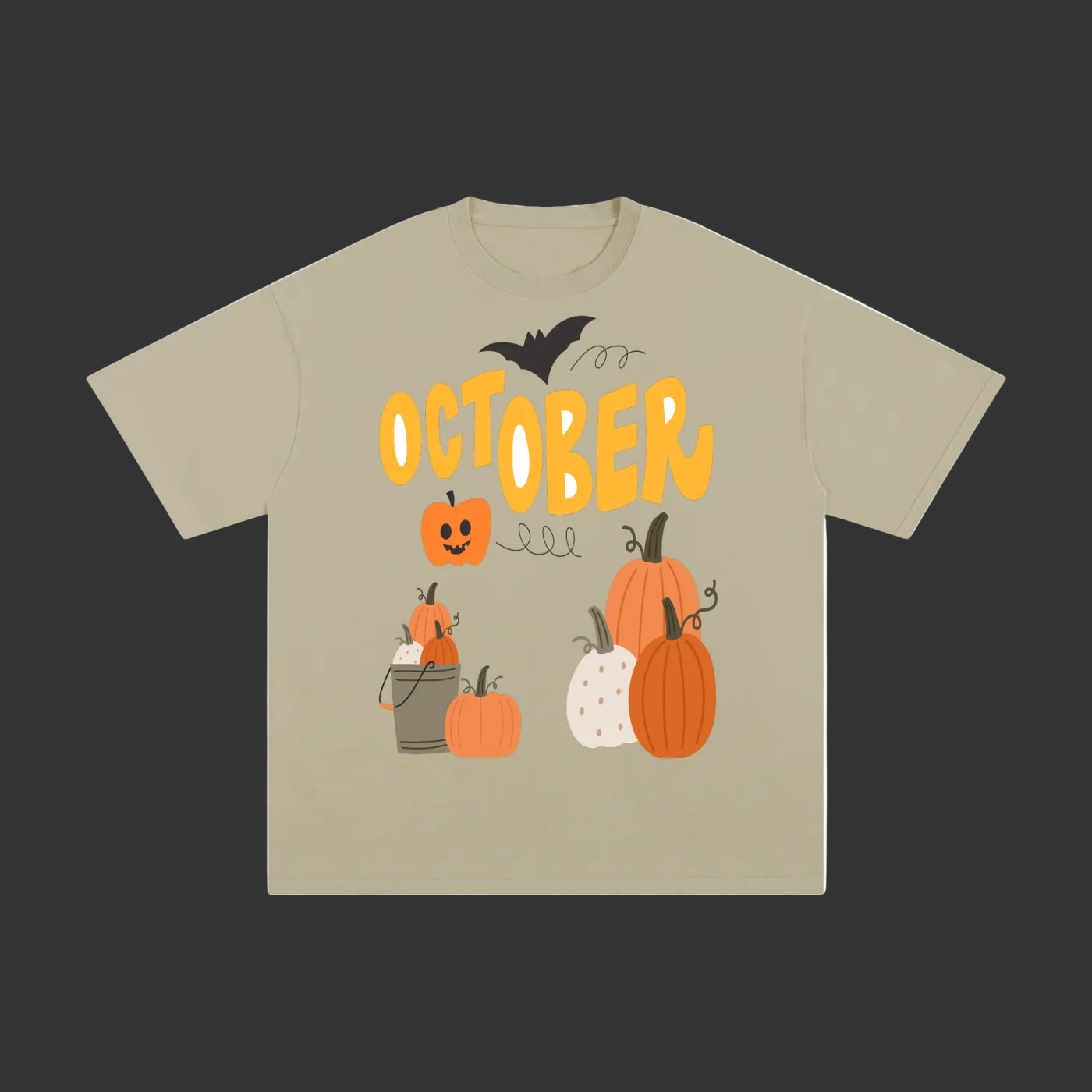 A beige short-sleeve t-shirt with a Halloween graphic on the front featuring the word 'OCTOBER' in yellow, pumpkins, a jack-o'-lantern, a bat, and a cat.