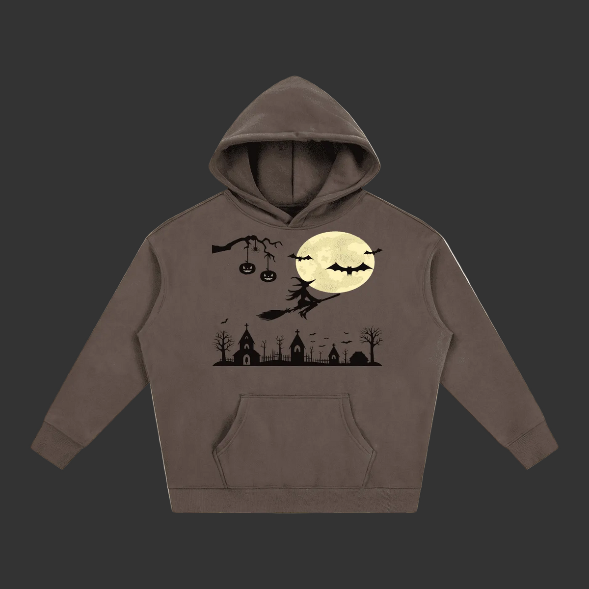 A dark brown pullover hoodie featuring a Halloween-themed graphic print on the front. The graphic includes a large cream-colored full moon, black bats, a witch riding a broomstick, a spooky church silhouette, and jack-o'-lanterns hanging from a branch.