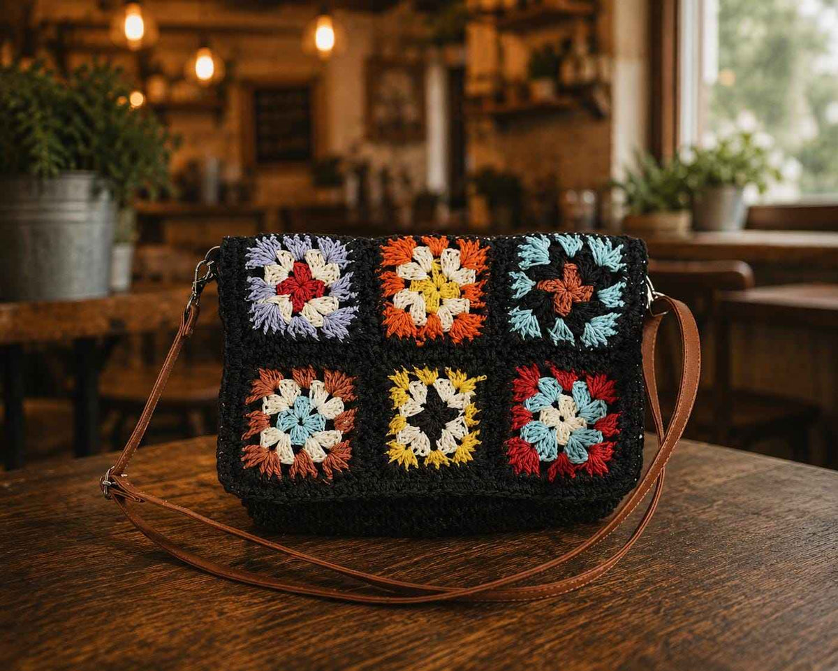 Handmade granny square crochet purse with colorful floral patchwork design and vintage boho style