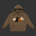 A brown pullover hoodie featuring a Halloween graphic of a black cat wearing a witch hat next to a carved orange pumpkin, surrounded by white candles and spiderwebs, shown on a plain gray background.
