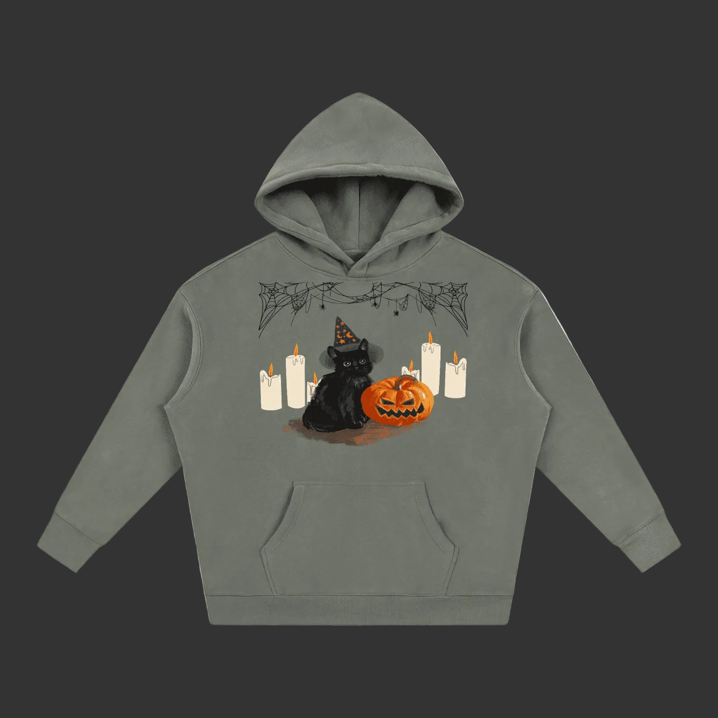 A sage green pullover hoodie featuring a Halloween graphic of a black cat wearing a witch hat next to a jack-o'-lantern pumpkin and white candles, displayed on a clean gray background.