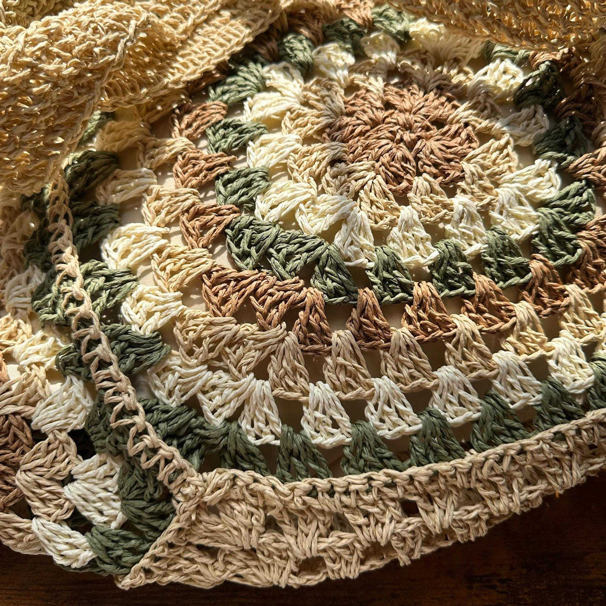 Detailed view of circular crochet stitching and woven texture on handmade boho tote bag