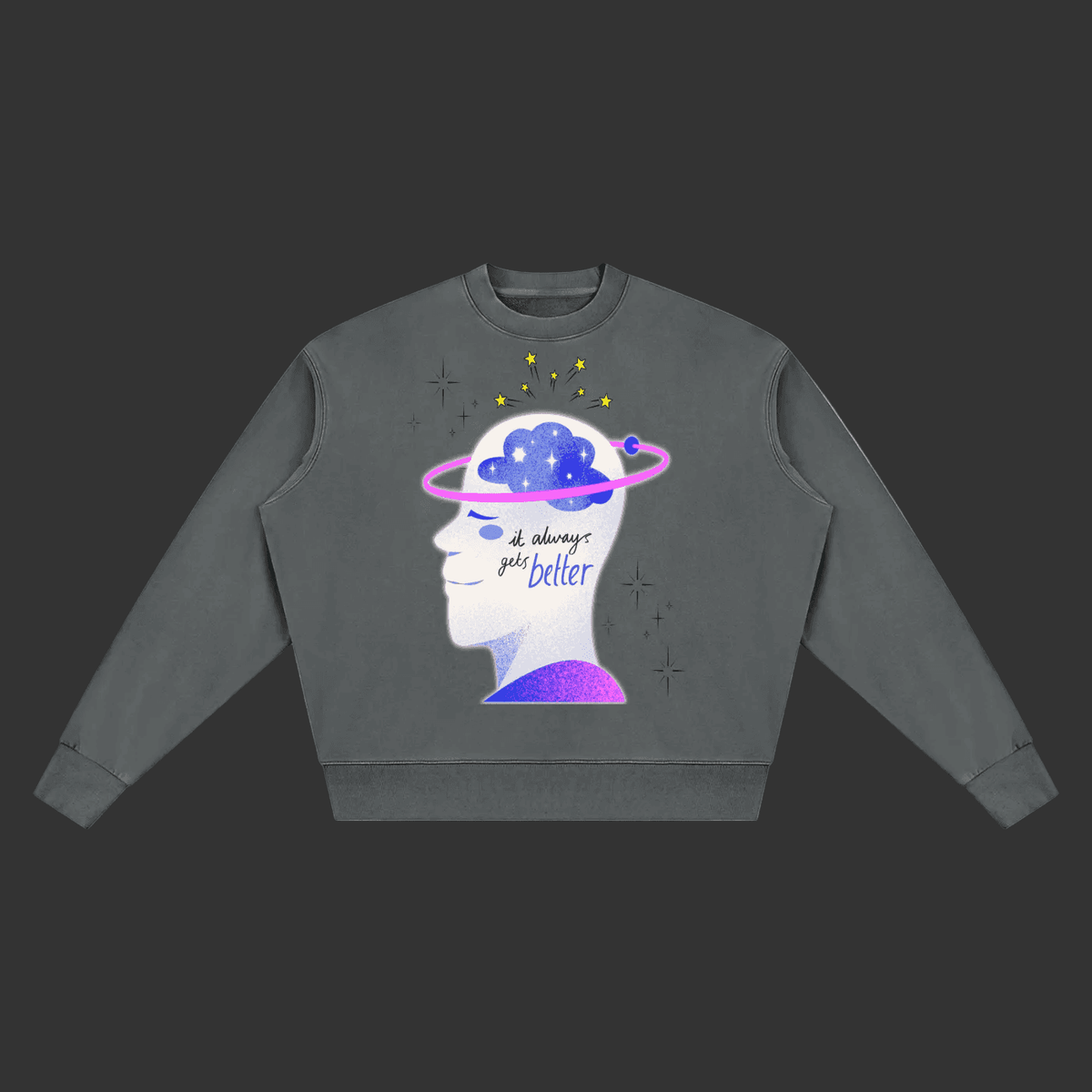A dark gray crewneck sweatshirt featuring a graphic of a human head profile with a Saturn-like ring and a blue cloud inside, accompanied by the text 'all things go better' in purple and black script.