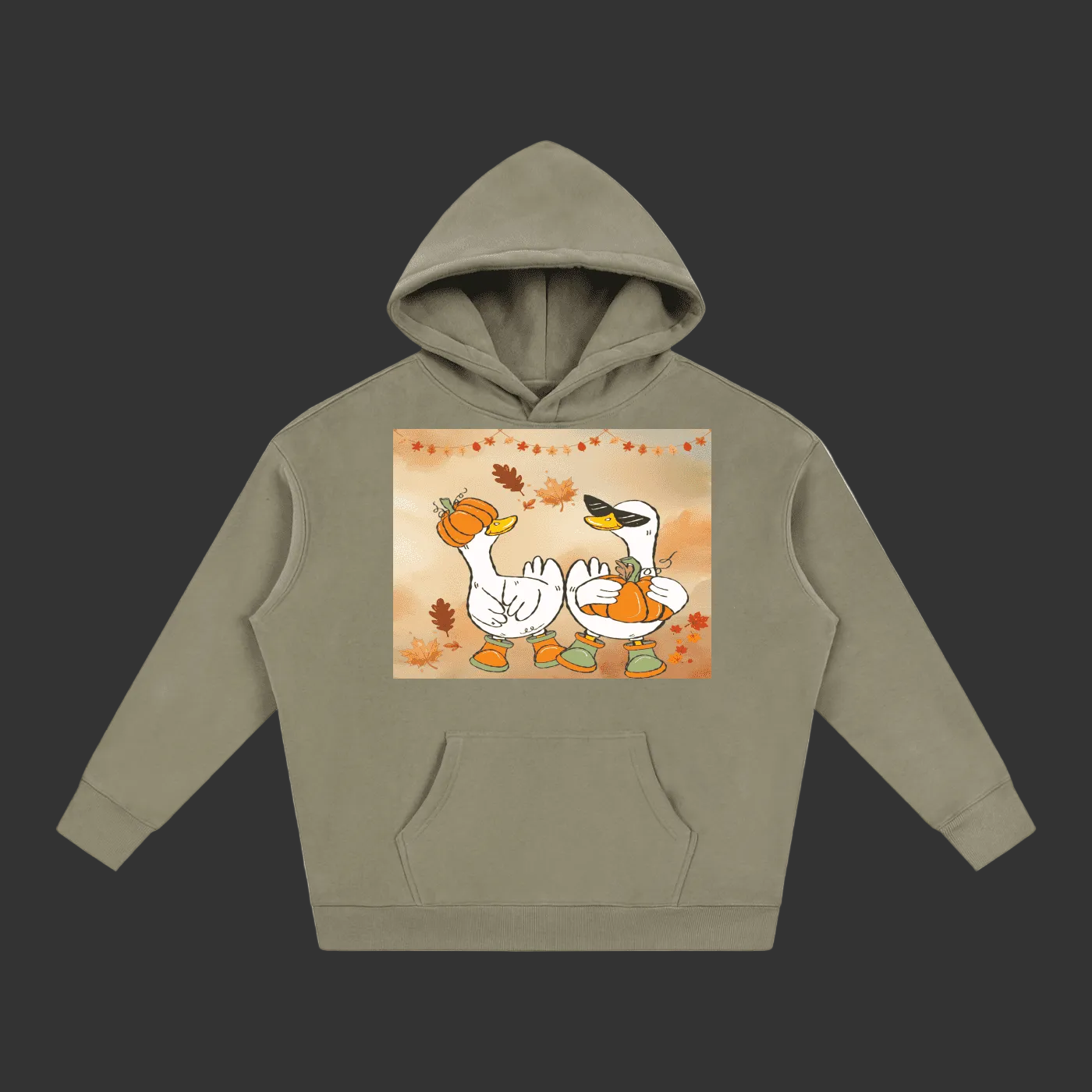 An olive green pullover hoodie with a front kangaroo pocket and a central graphic print of two cartoon white swans holding pumpkins, set against a plain gray background