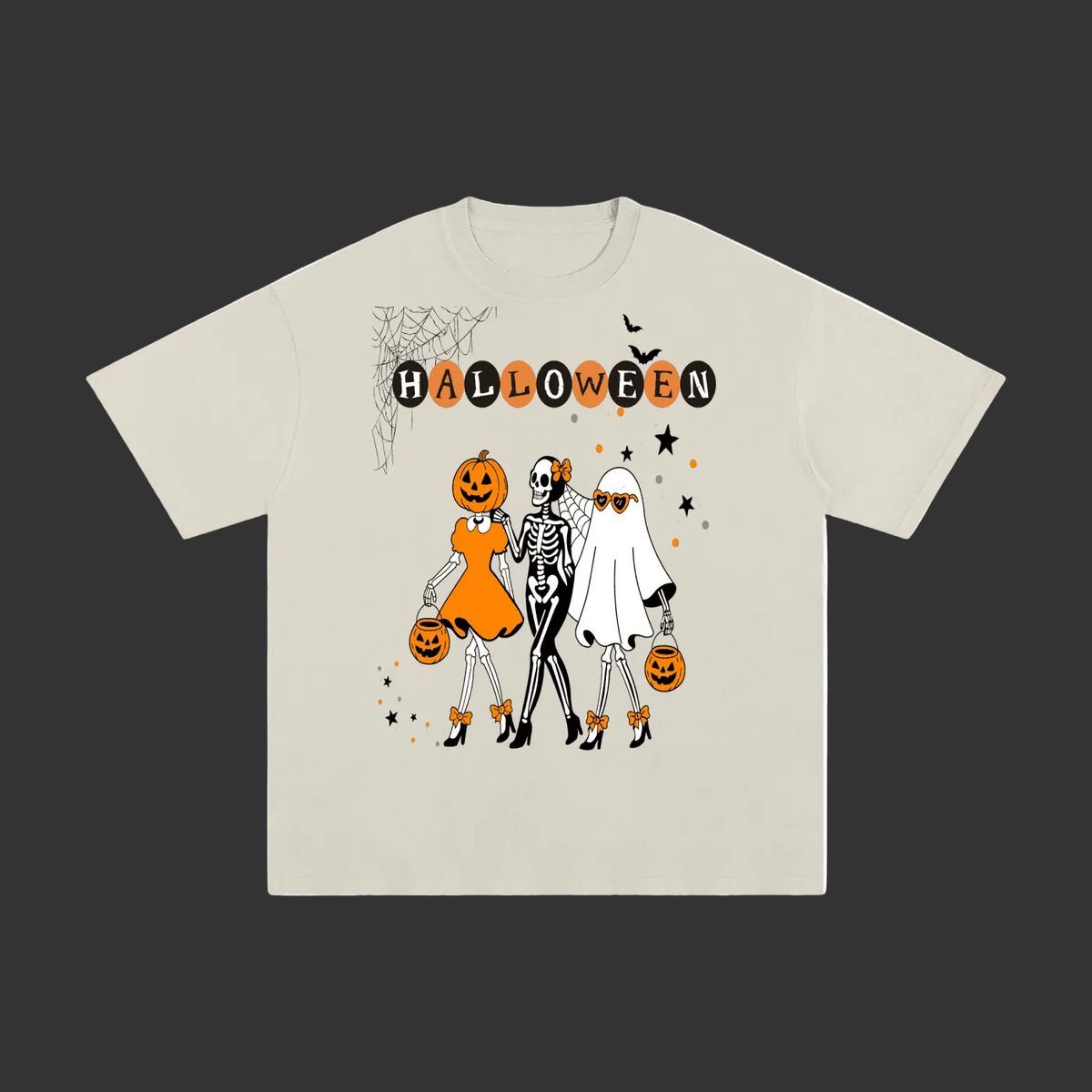 A light beige crewneck t-shirt featuring a Halloween graphic print with the word 'HALLOWEEN' in black letters, a spiderweb, and three cartoon characters dressed as a pumpkin, a skeleton, and a ghost holding pumpkins.