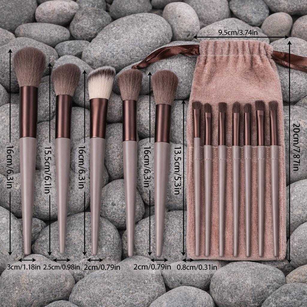 set set of makeup brushes lined up on grey stones