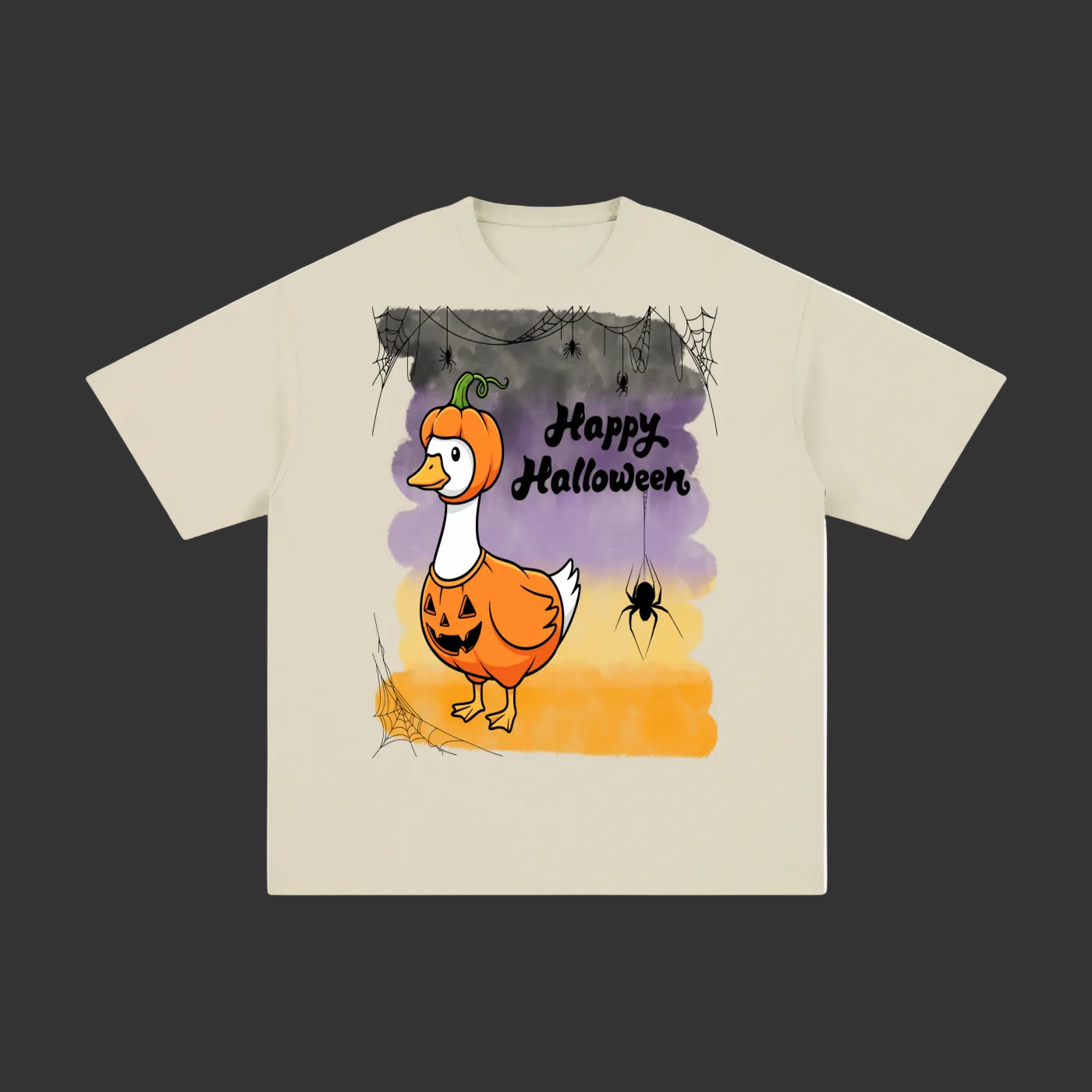 A light beige short-sleeve t-shirt with a graphic print of a cartoon duck dressed as a pumpkin with 'Happy Halloween' text and a spider on a purple and orange background.