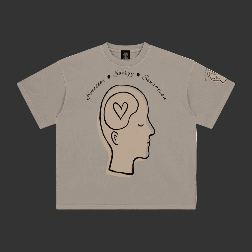 A light gray crewneck t-shirt featuring a graphic of a side profile of a head with a heart inside, with the words 'Emotion', 'Energy', and 'Suggestion' written above it.