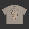 A light gray crewneck t-shirt featuring a graphic of a side profile of a head with a heart inside, with the words 'Emotion', 'Energy', and 'Suggestion' written above it.