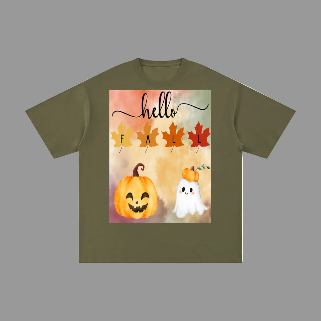An olive green short-sleeve t-shirt with a square graphic print on the front featuring the text 'hello fall' in script and leaf shapes, above a smiling orange jack-o'-lantern and a small white ghost.