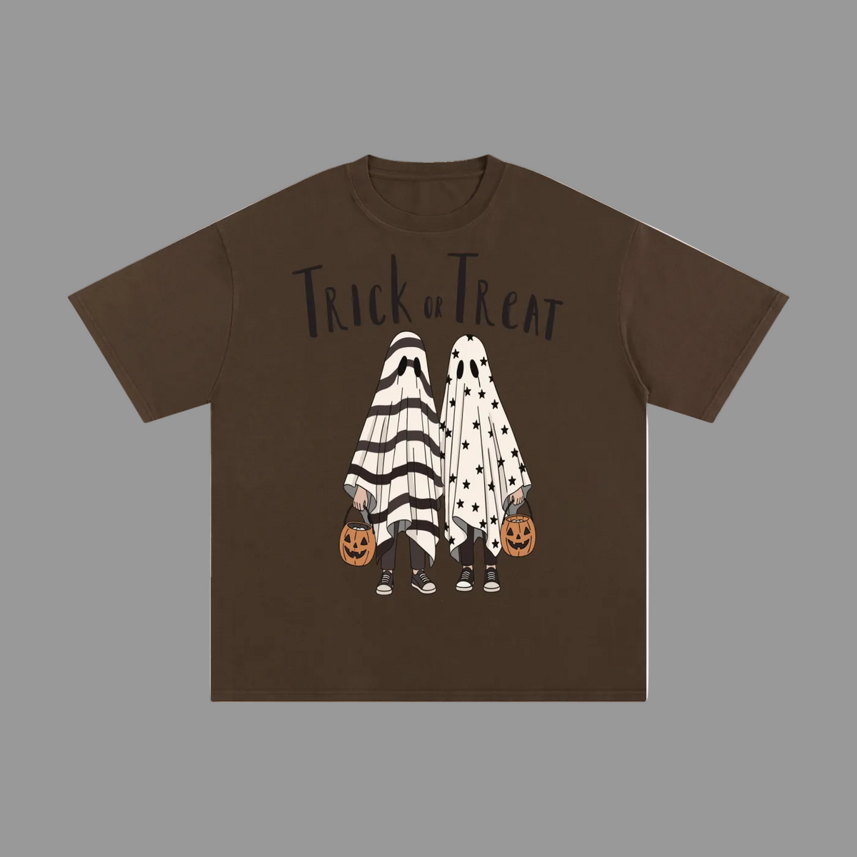 A brown short-sleeve t-shirt with a 'Trick or Treat' Halloween graphic on the front, featuring two ghost figures in black-and-white striped and black-and-white polka dot costumes holding jack-o'-lanterns, displayed on a solid gray background.