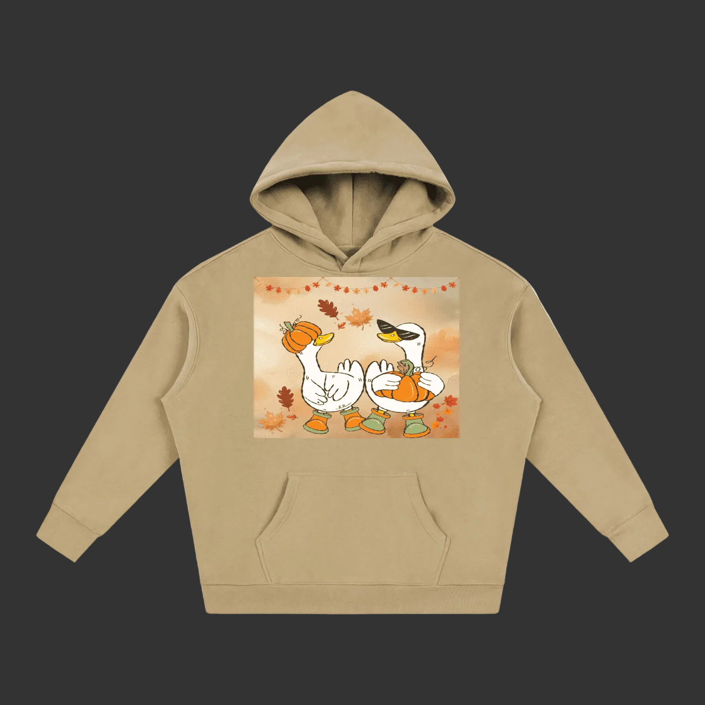 A beige pullover hoodie with a front kangaroo pocket and a central graphic print of two cartoon geese holding pumpkins, surrounded by autumn leaves, on a plain gray background.