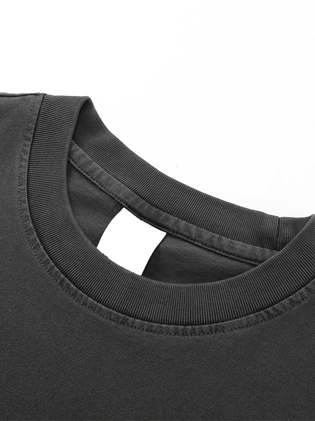 Close-up of a black t-shirt collar on a white background