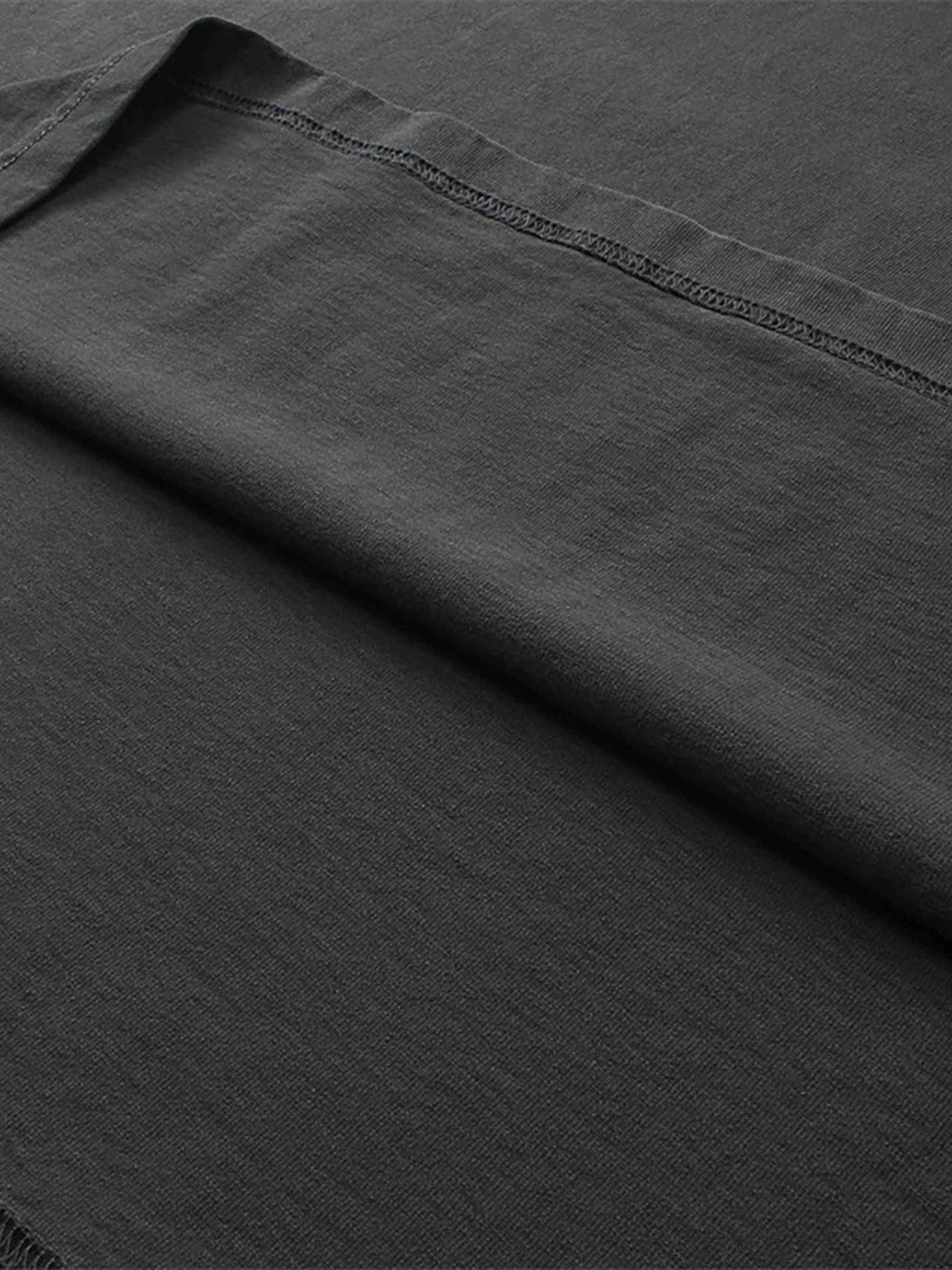 Close-up of dark gray fabric with a visible seam