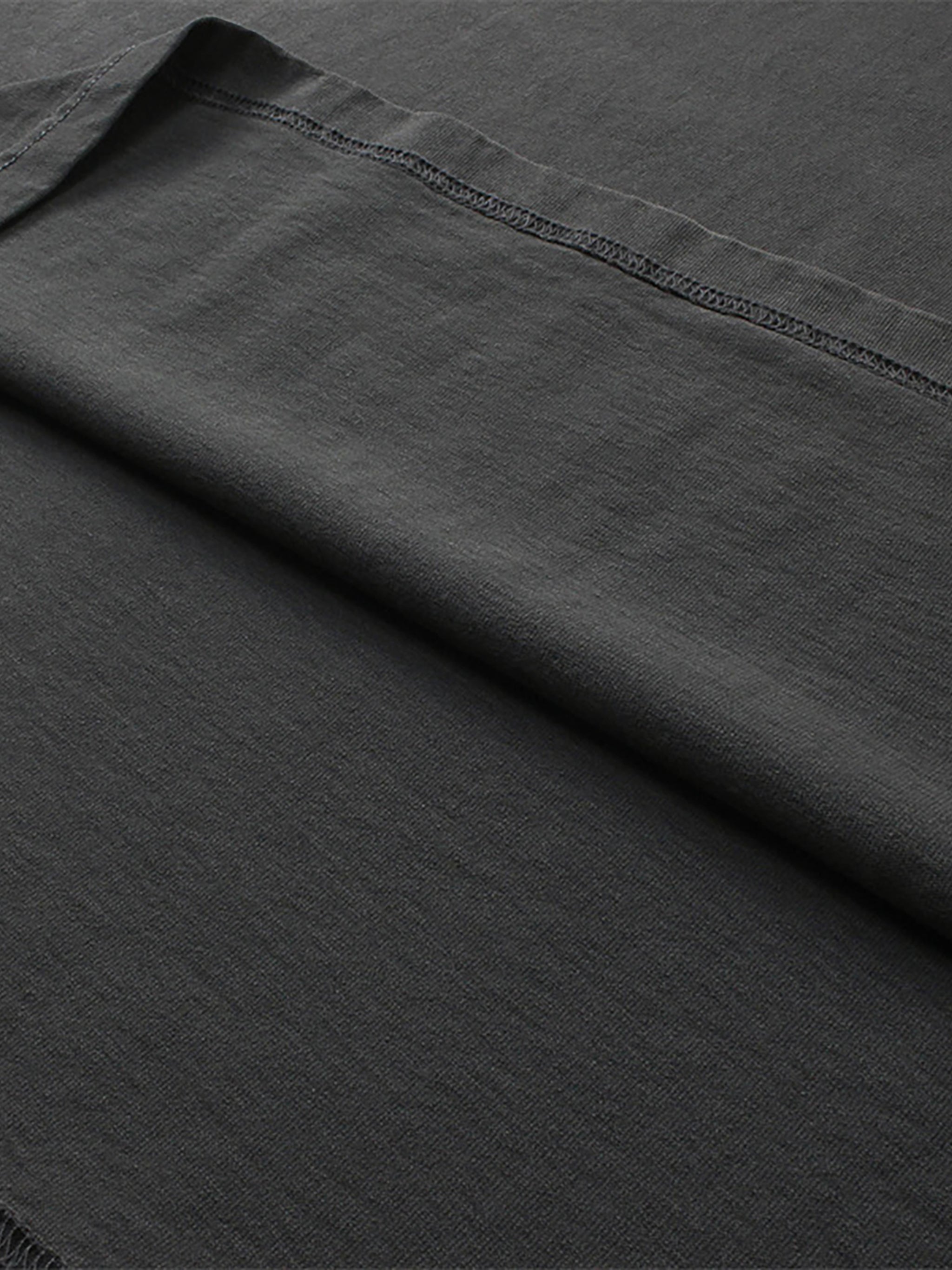 Close-up of dark gray fabric with a visible seam