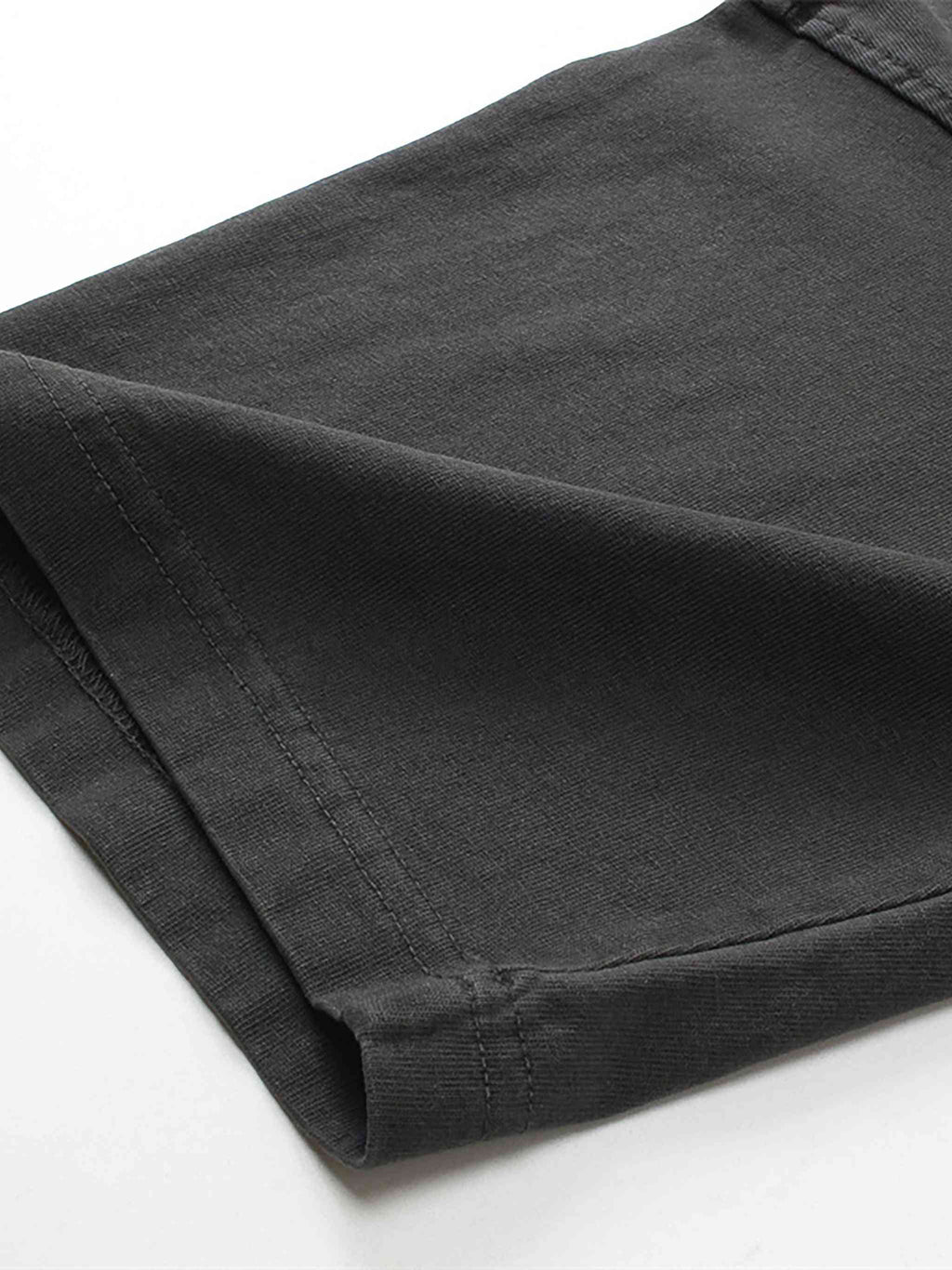Folded black pants on a white background