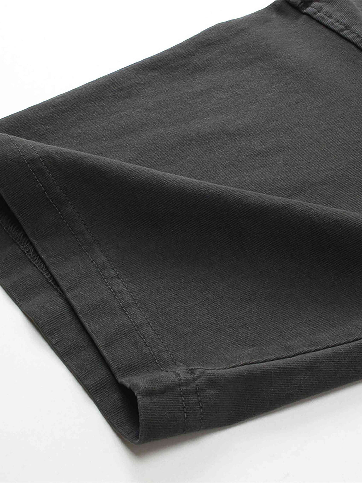 Folded black pants on a white background