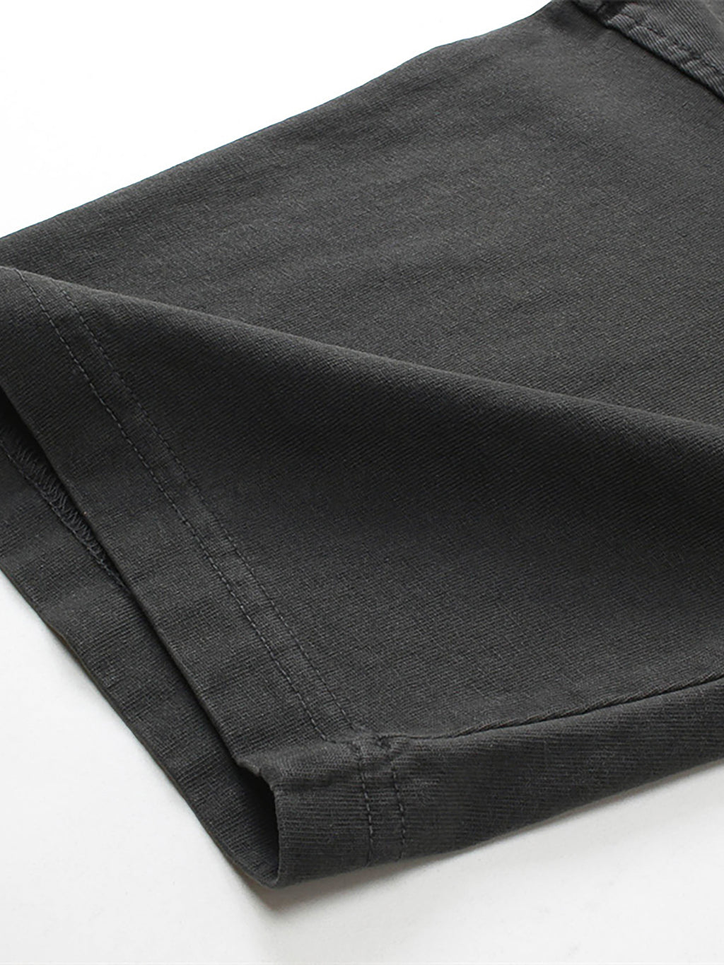 Folded black pants on a white background